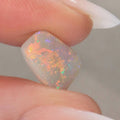 Detail of bright orange-green flash on light opal