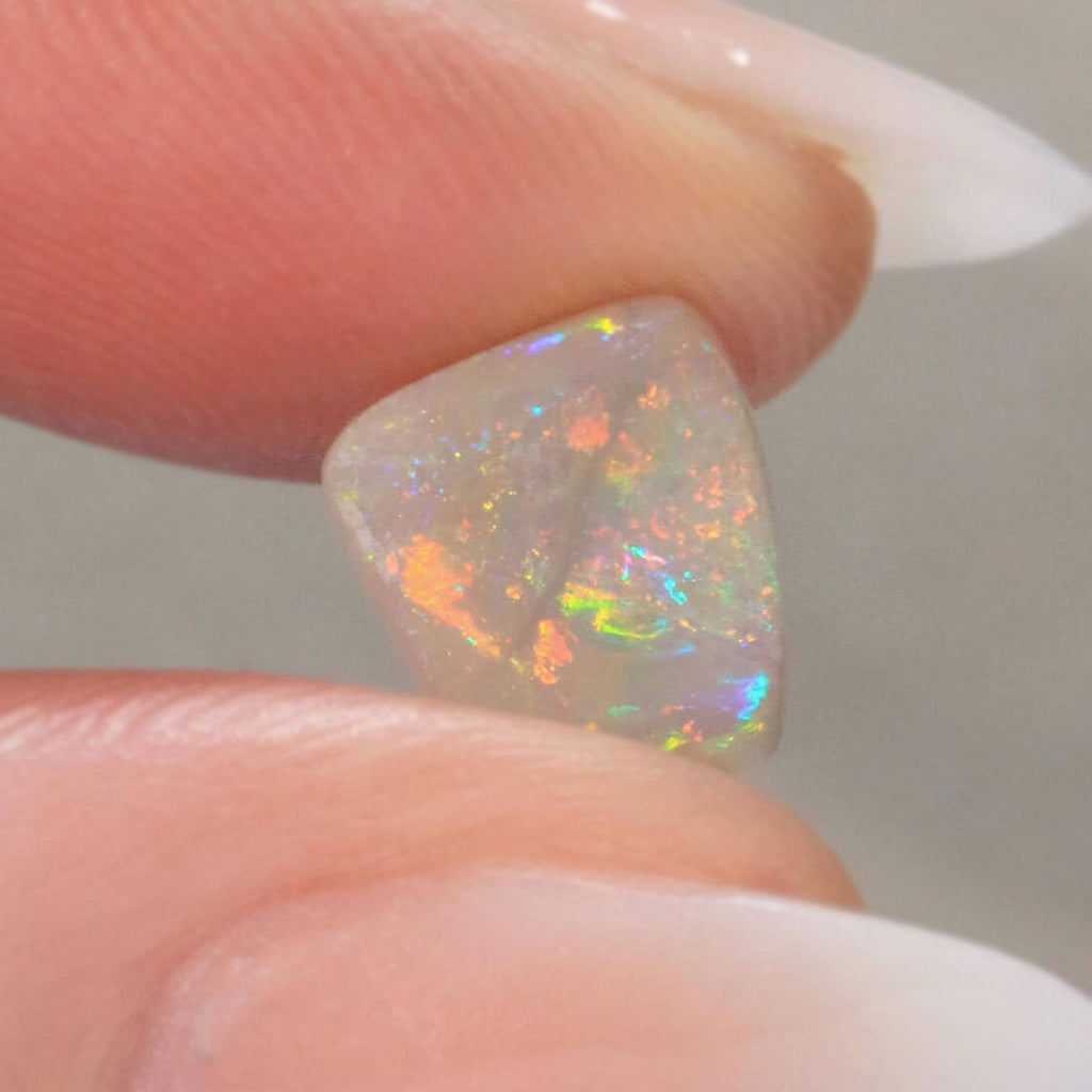 1.3ct light opal held in hand for scale reference