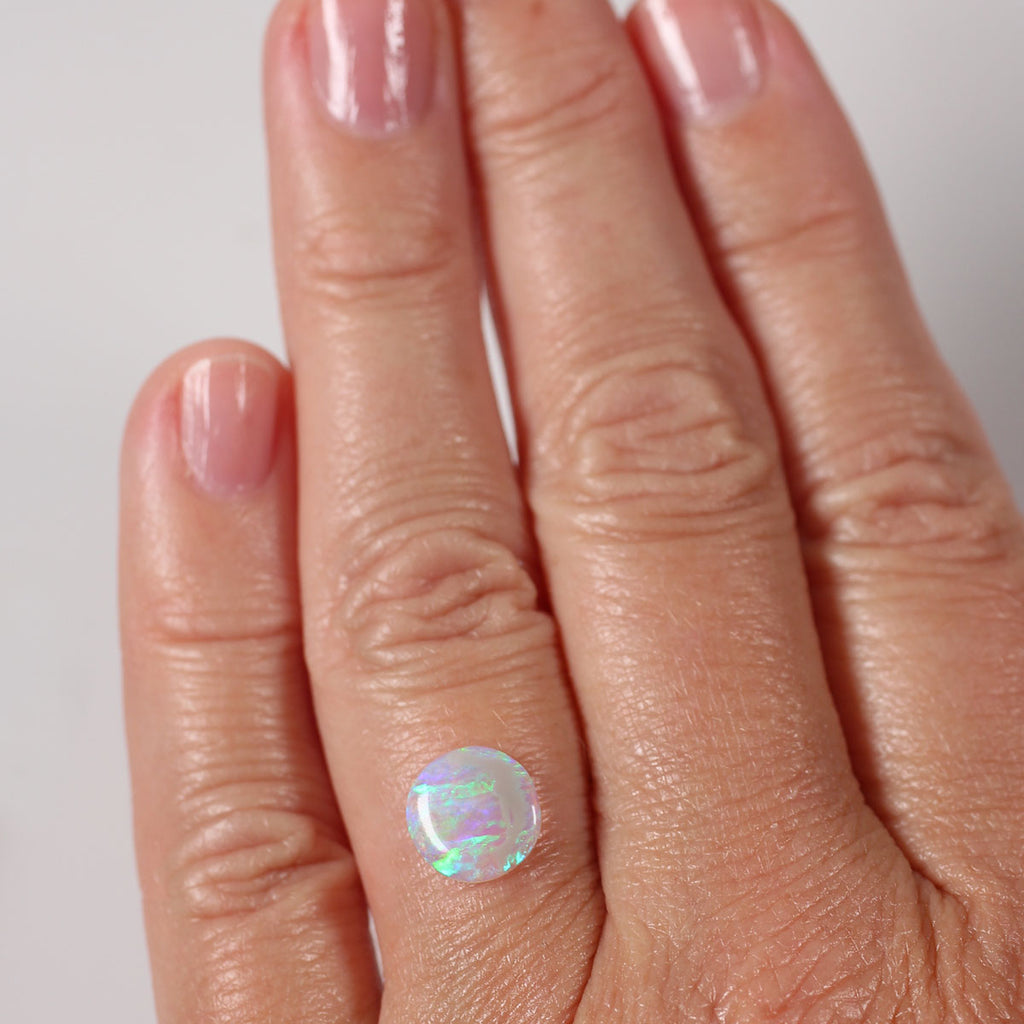 Side view of blue-green light crystal opal cabochon