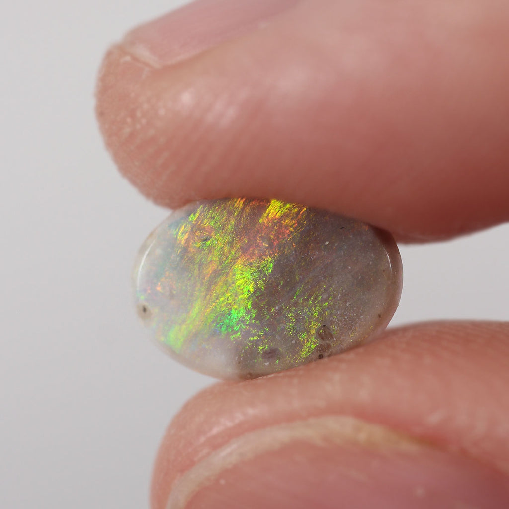 Natural dark opal from Lightning Ridge, 0.9ct with bright orange-green flash