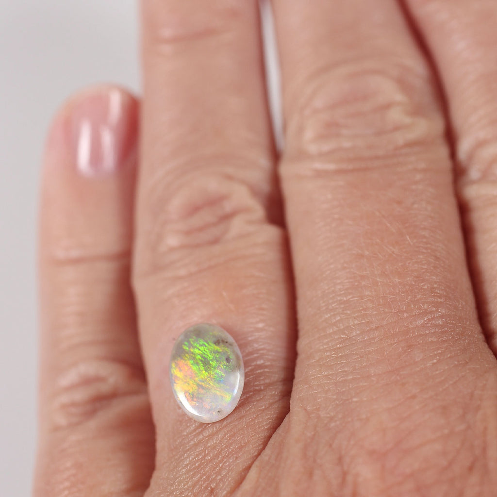 Side profile of 0.9ct dark opal showing natural solid body