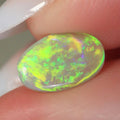 1.15ct dark opal held in hand for scale reference