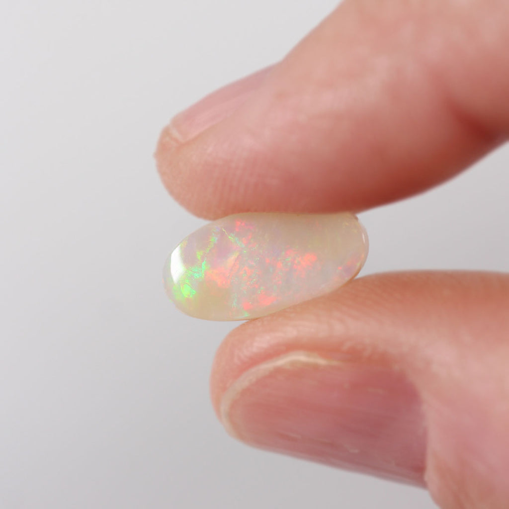 2.05ct light opal held in hand for scale reference
