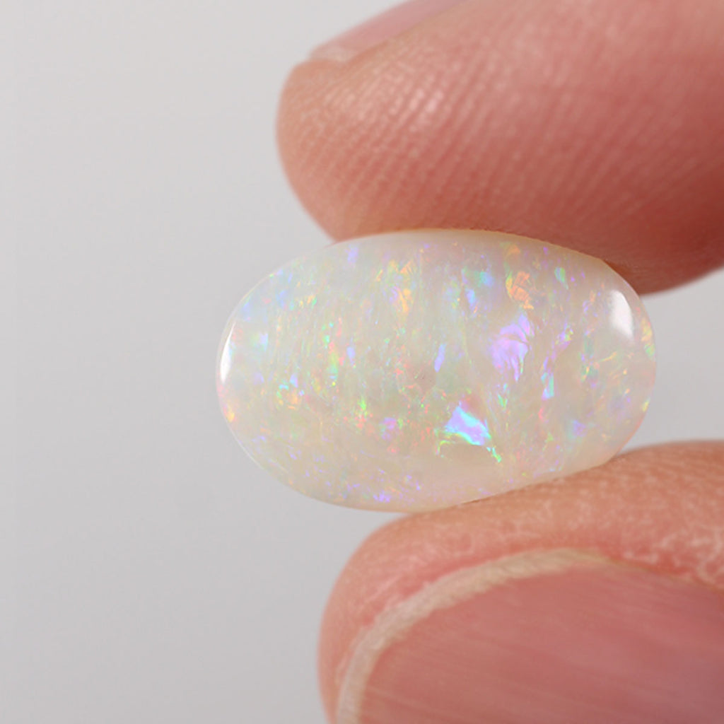 2.85ct light opal held in hand for scale reference