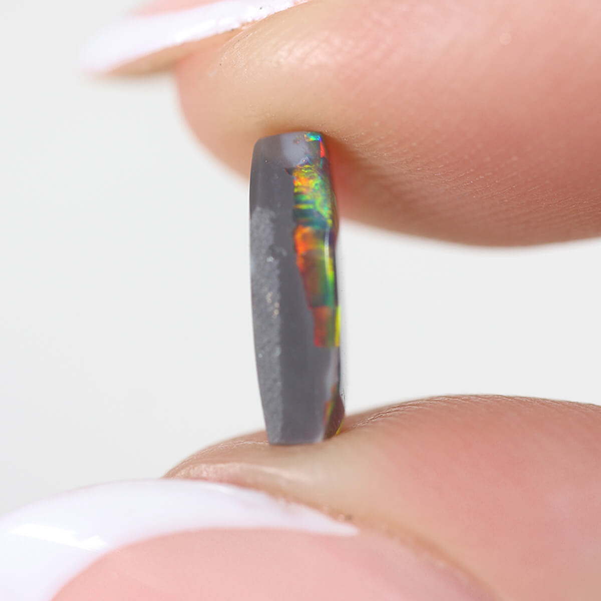 1.26ct Black Opal - 5.5 x 9.5 x 3mm