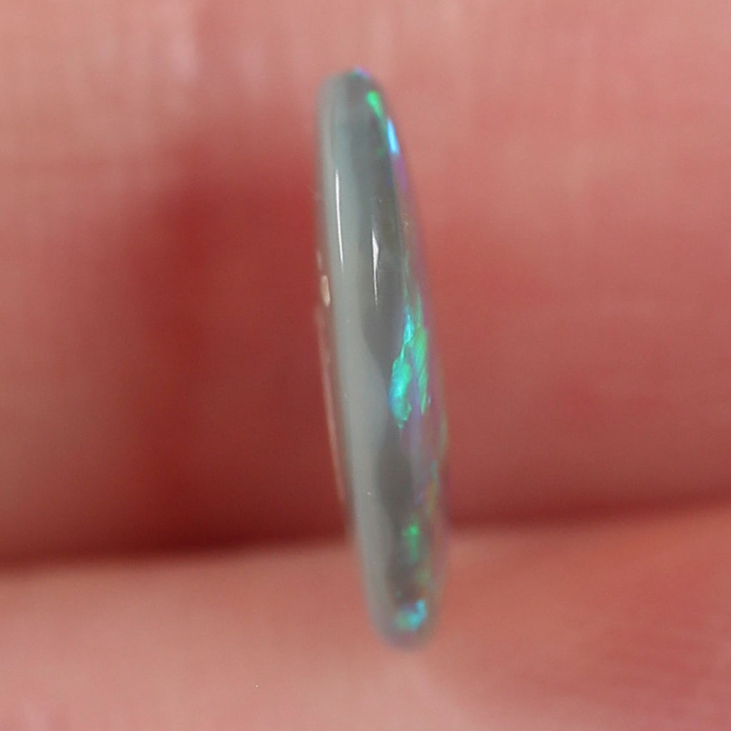 Macro detail of dark crystal opal cabochon