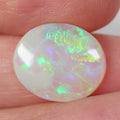 Crystal opal from Lightning Ridge held in hand to show scale