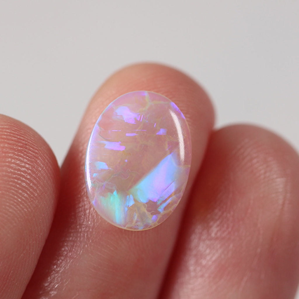 1.86ct light crystal opal held in hand for scale reference
