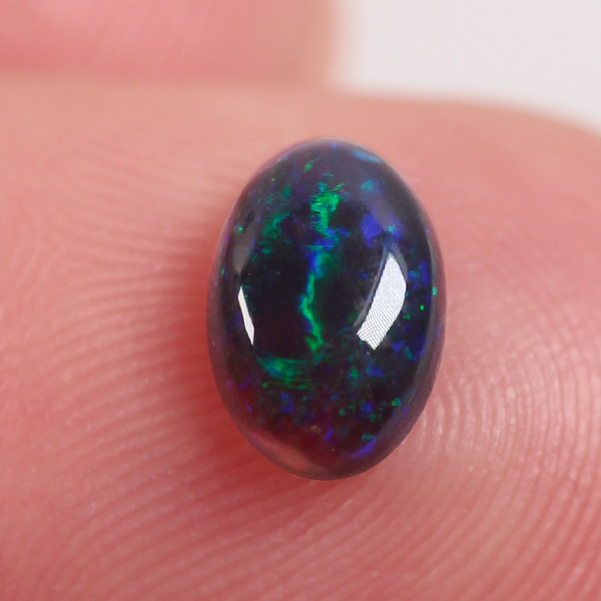 0.6 ct Black Opal - 5.2 x 6.6 x 3mm