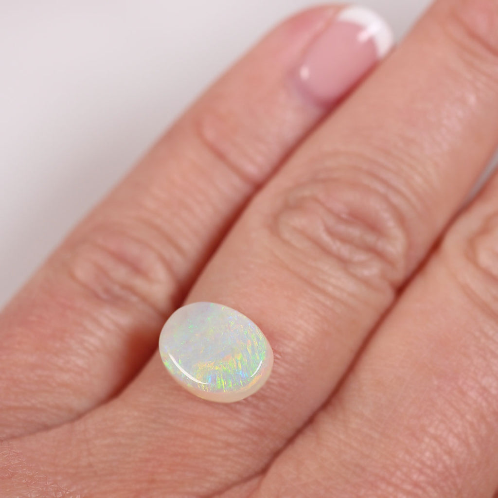 2.1ct light opal held in hand for scale reference