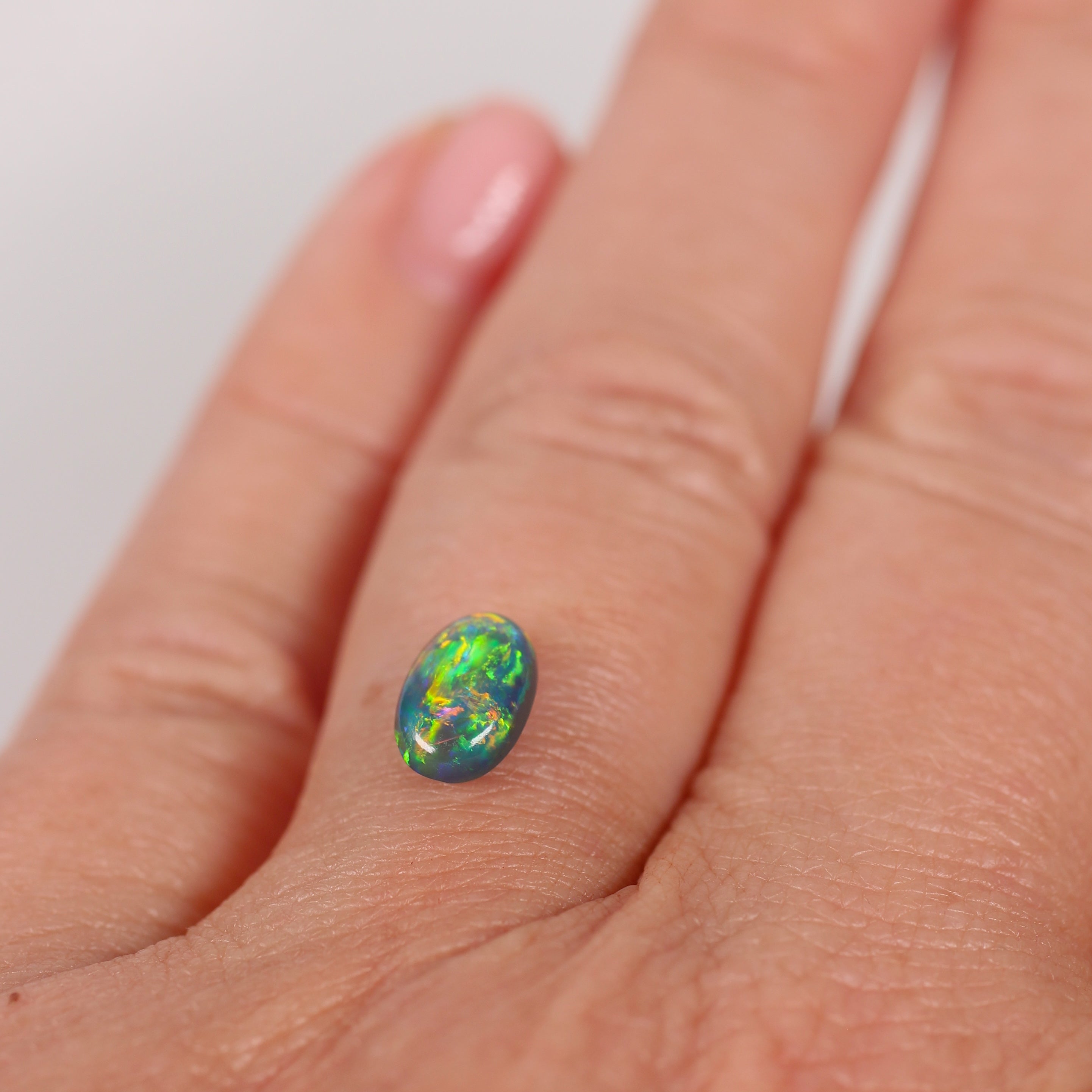 0.91ct Black Opal - 5.4 x 8.3 x 3.5mm