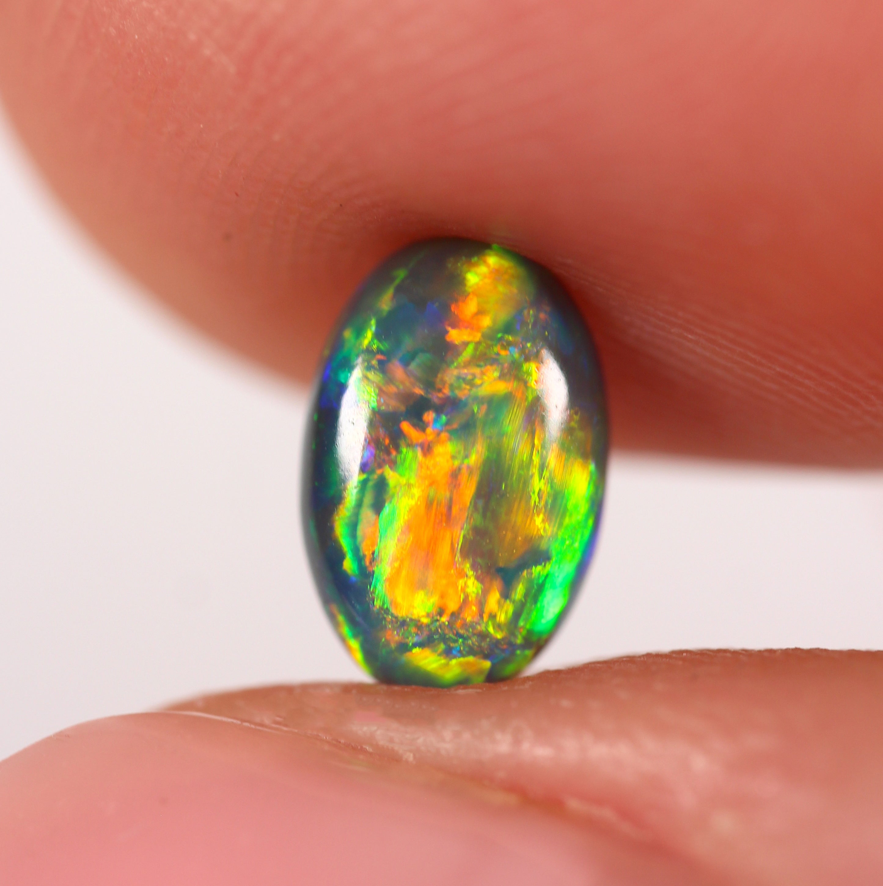 0.91ct Black Opal - 5.4 x 8.3 x 3.5mm