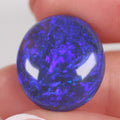 16.04ct Australian black crystal opal cabochon with purple-blue galaxy