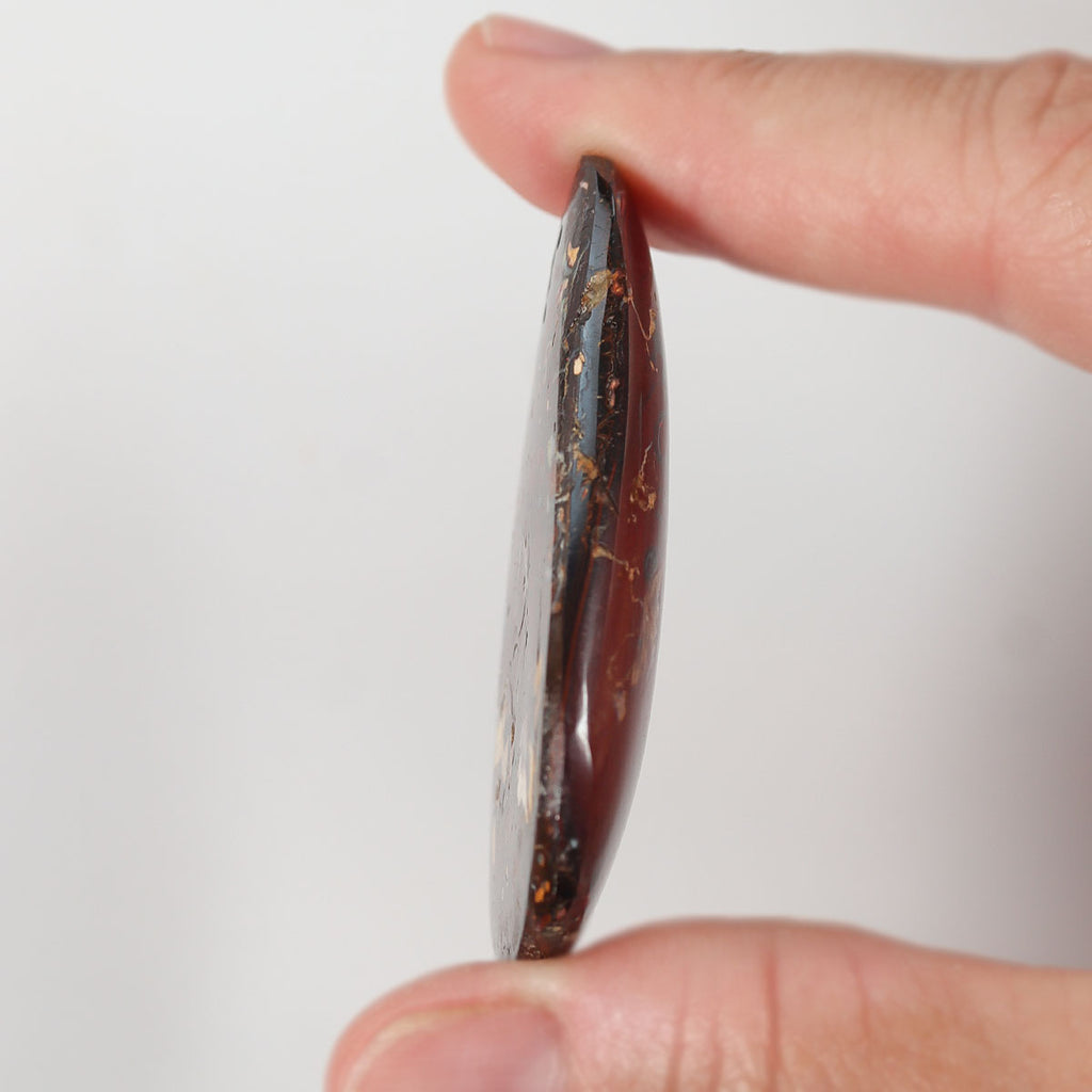 Boulder matrix from Koroit held in hand to show scale