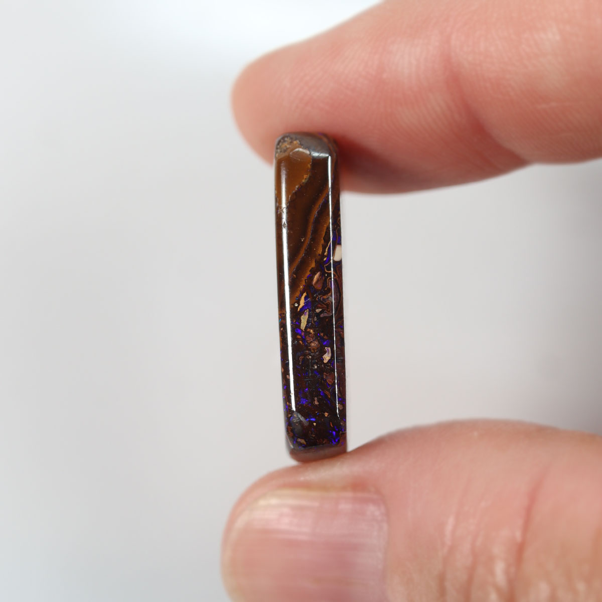 Side view of purple boulder matrix cabochon