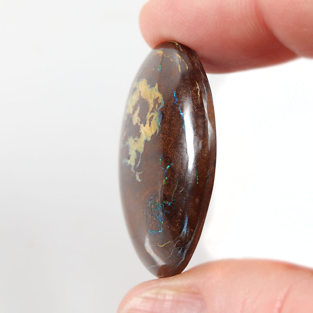 48.82ct boulder matrix held in hand for scale reference