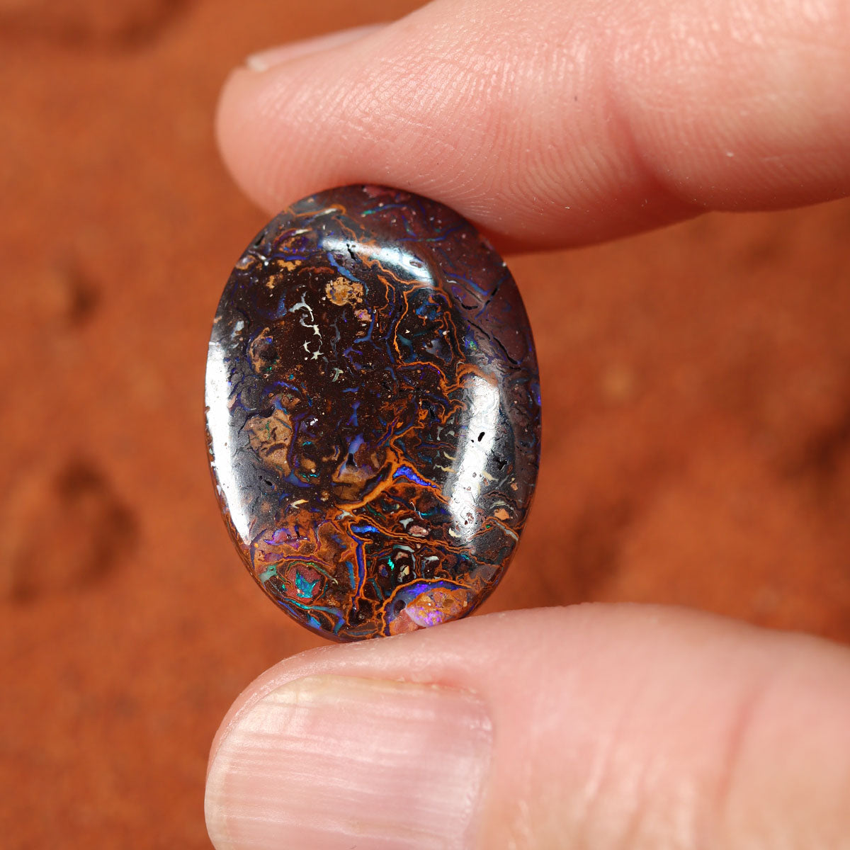Boulder matrix surface detail showing blue play-of-colour