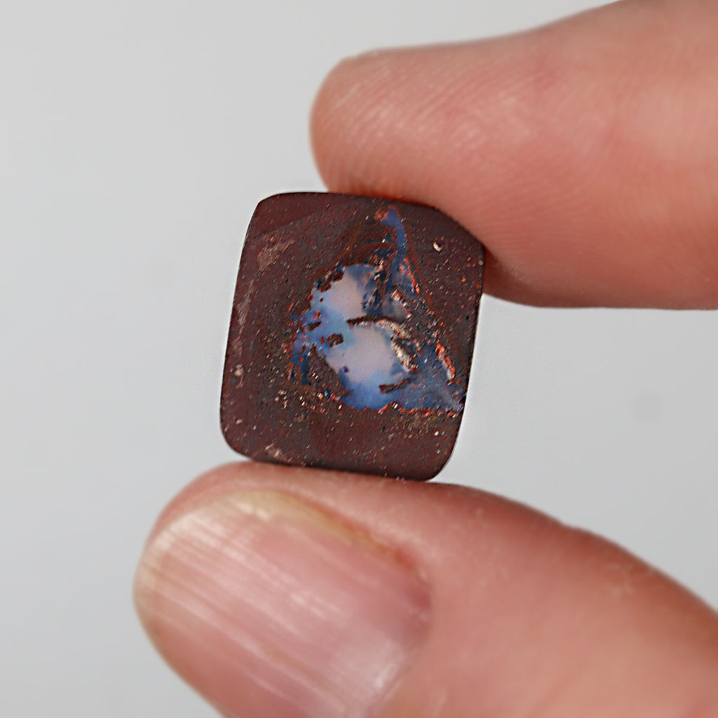 Side view of blue boulder opal cabochon