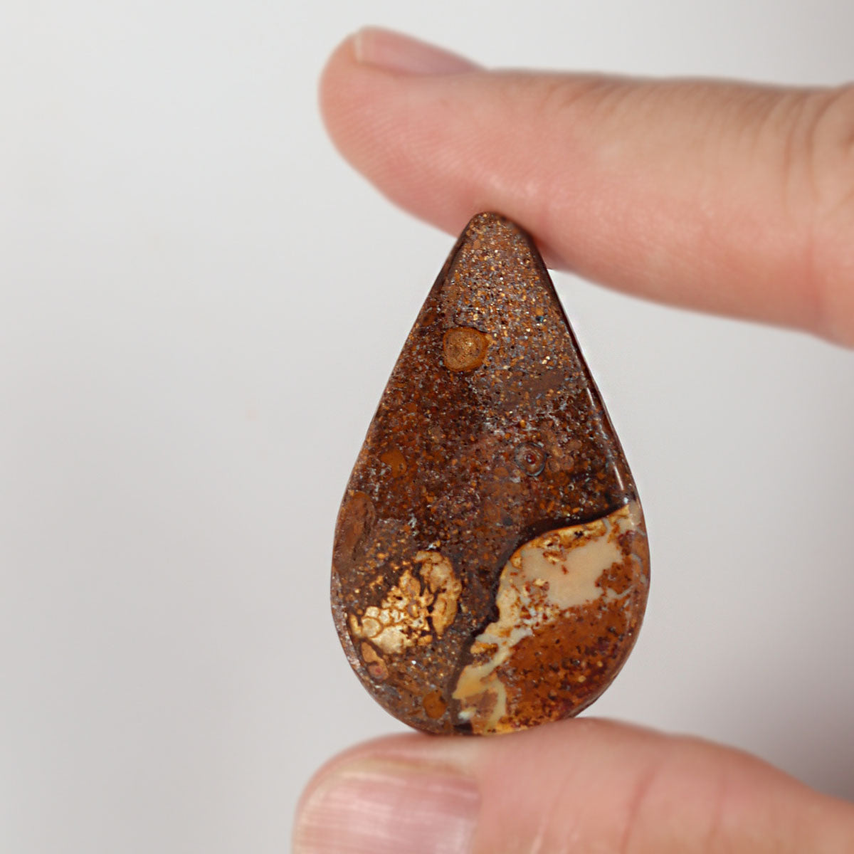Side profile of 34.61ct boulder matrix showing natural solid body