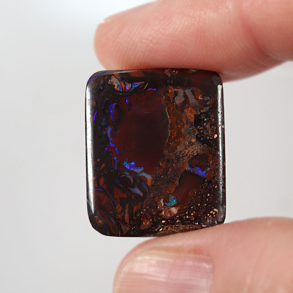 Side view of green boulder matrix cabochon