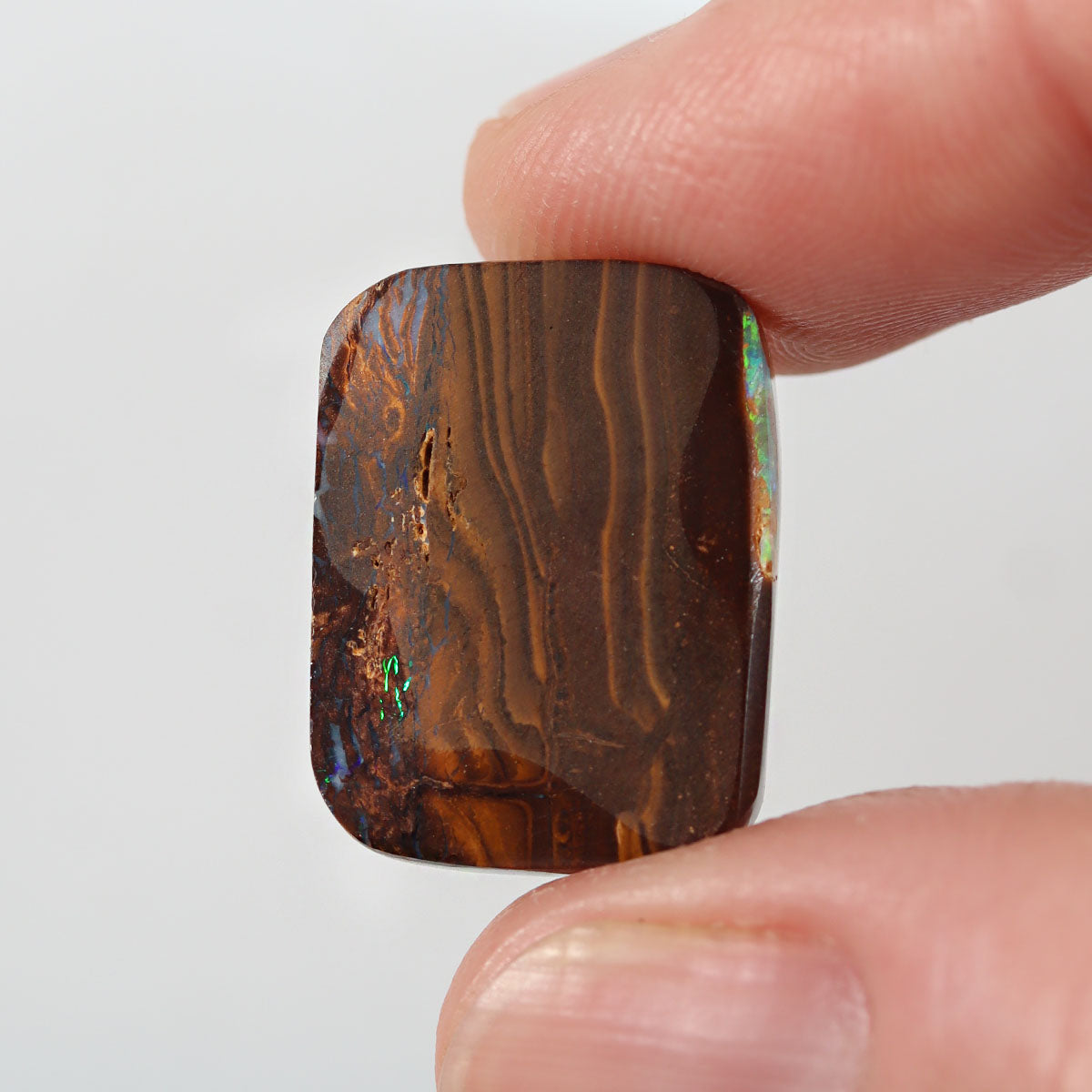 Side view of green boulder matrix cabochon