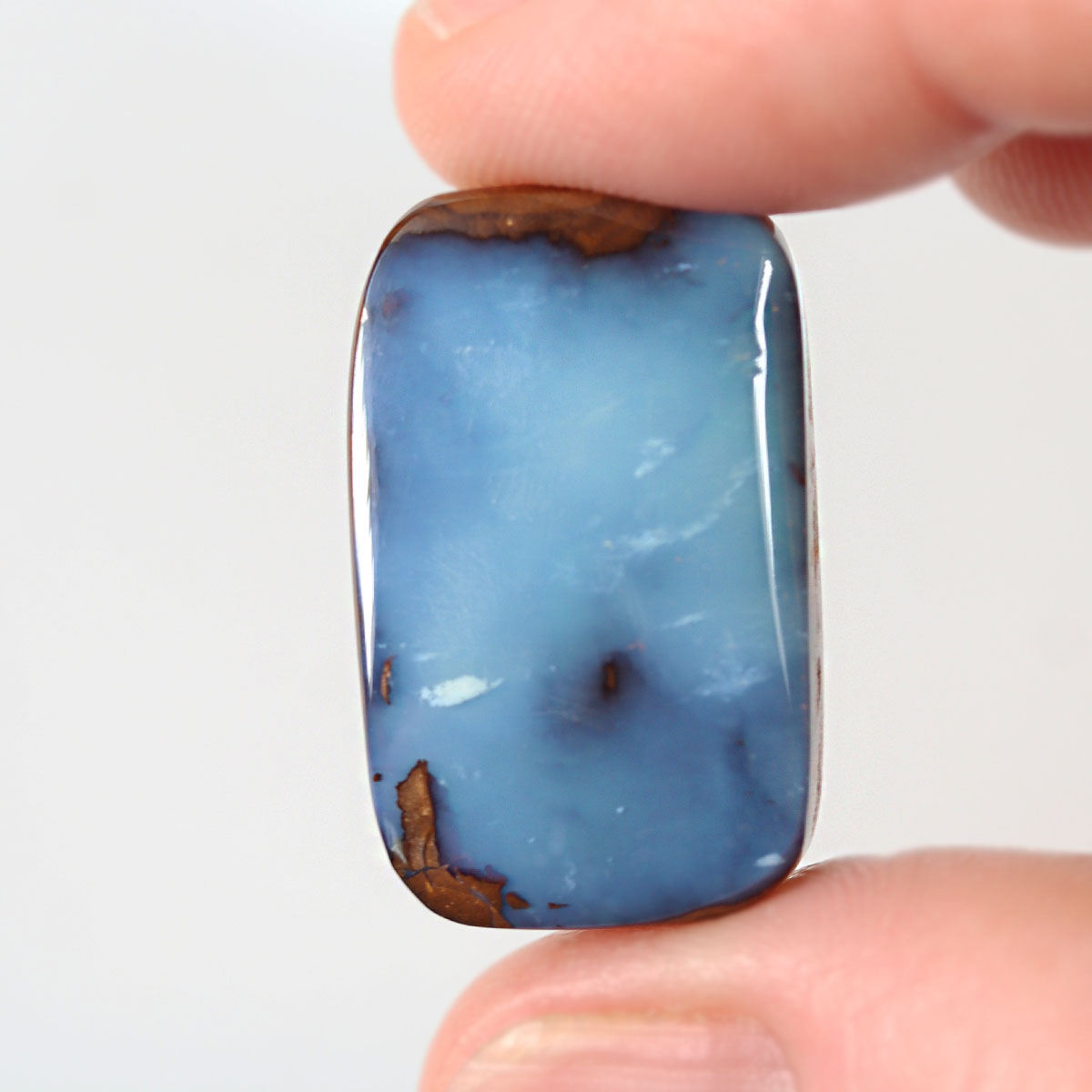 25.83ct soft blue boulder opal cabochon with picture stone pattern