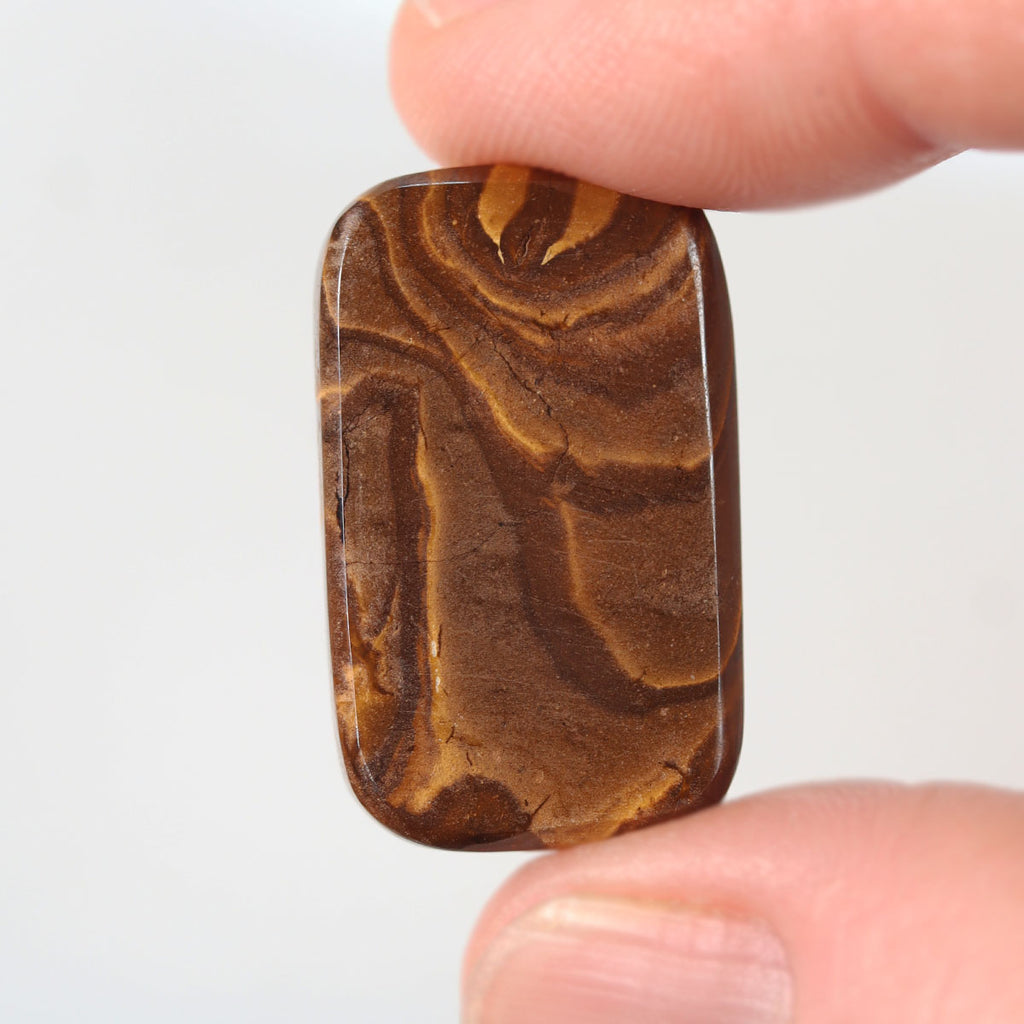 Side view of blue boulder opal cabochon