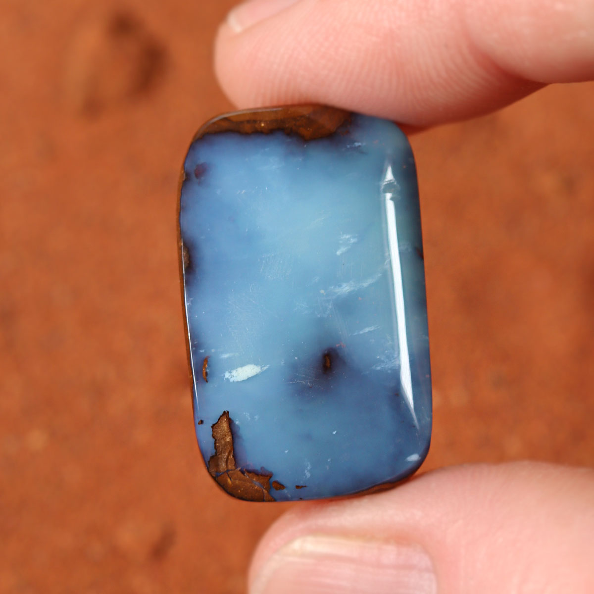 Boulder opal surface detail showing blue play-of-colour