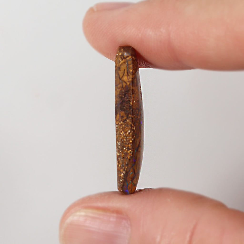 14.86ct boulder matrix held in hand for scale reference