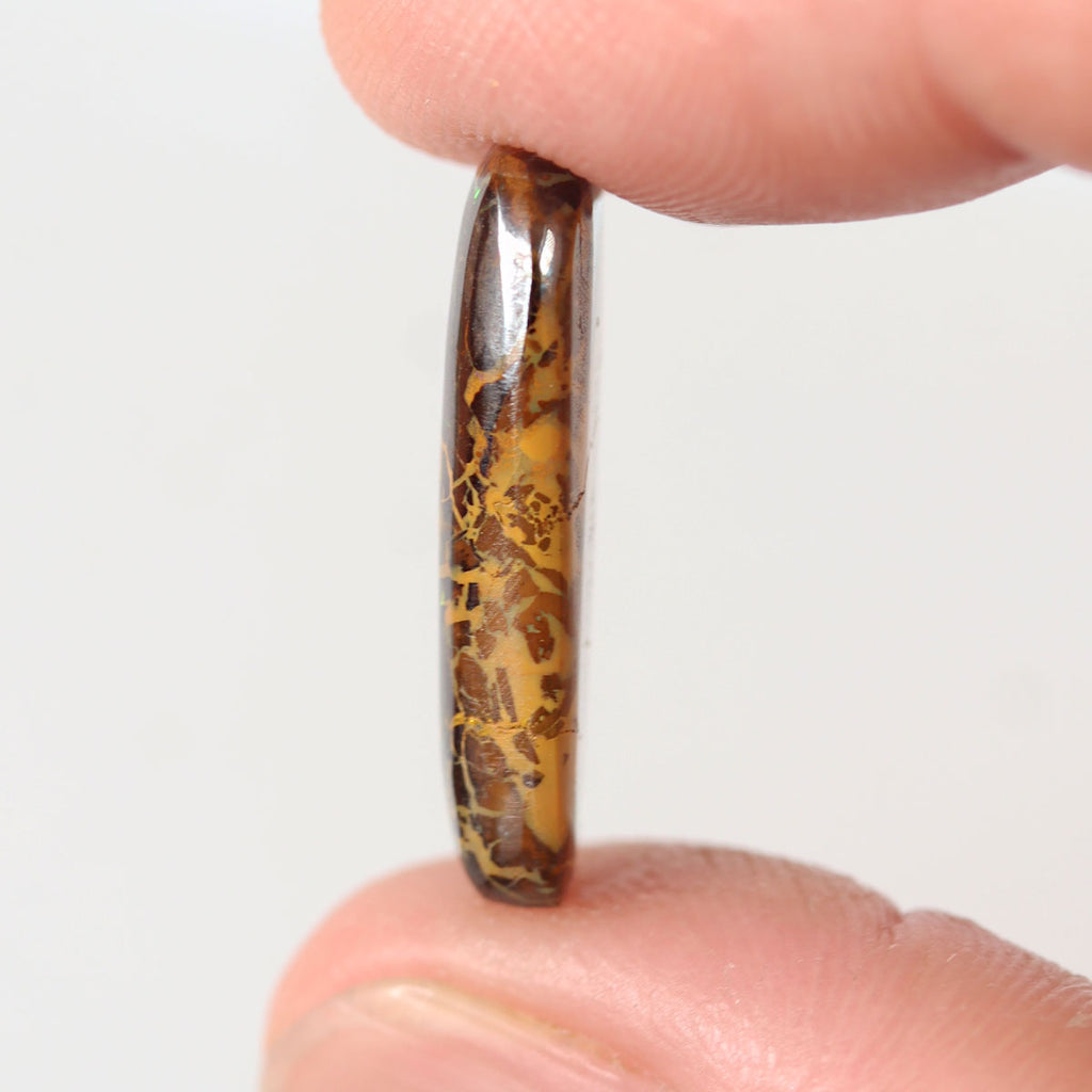 7.79ct boulder matrix held in hand for scale reference