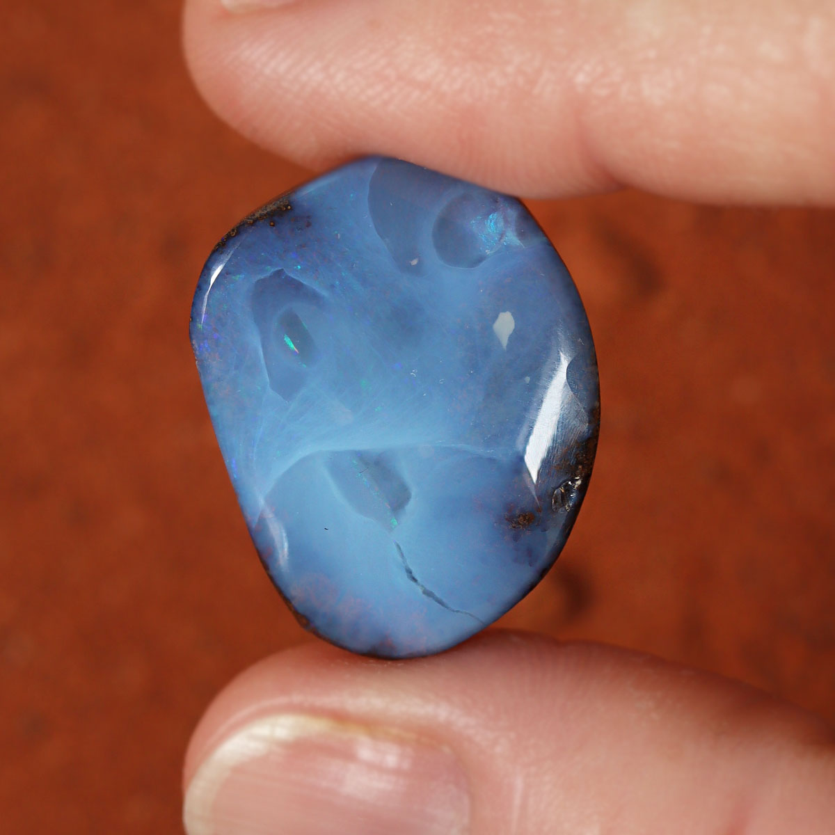 Macro detail of boulder opal cabochon
