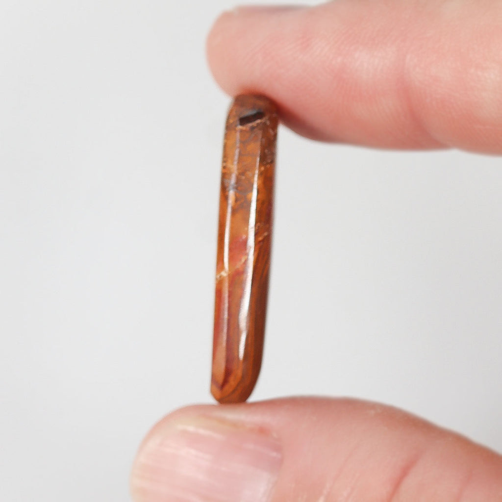 19.25ct boulder matrix held in hand for scale reference