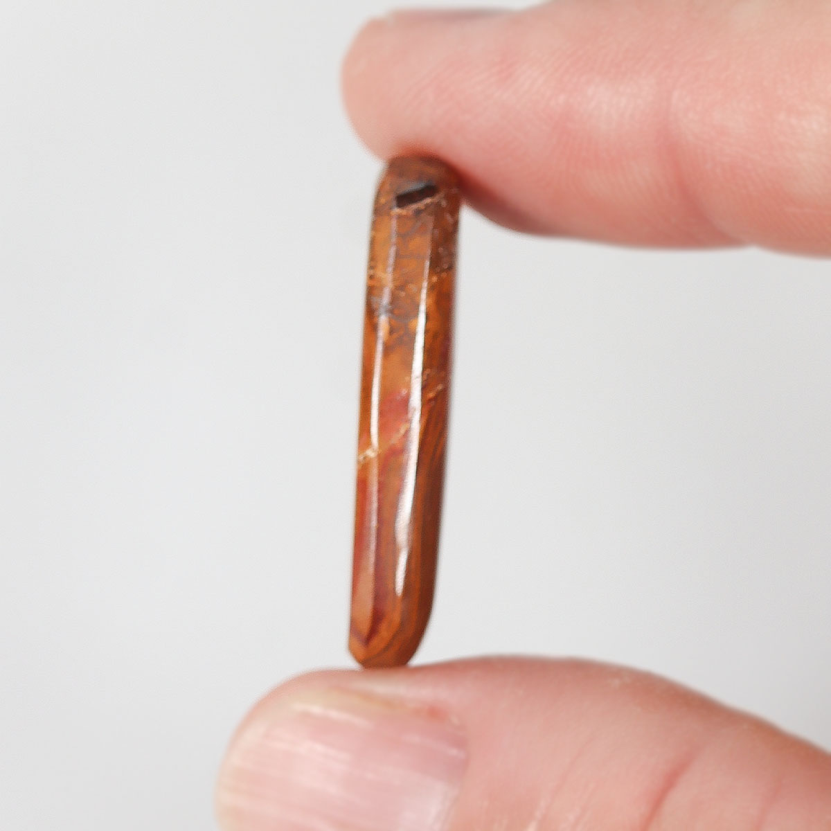 19.25ct boulder matrix held in hand for scale reference