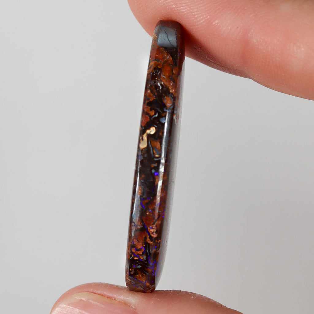 51.94ct boulder matrix held in hand for scale reference