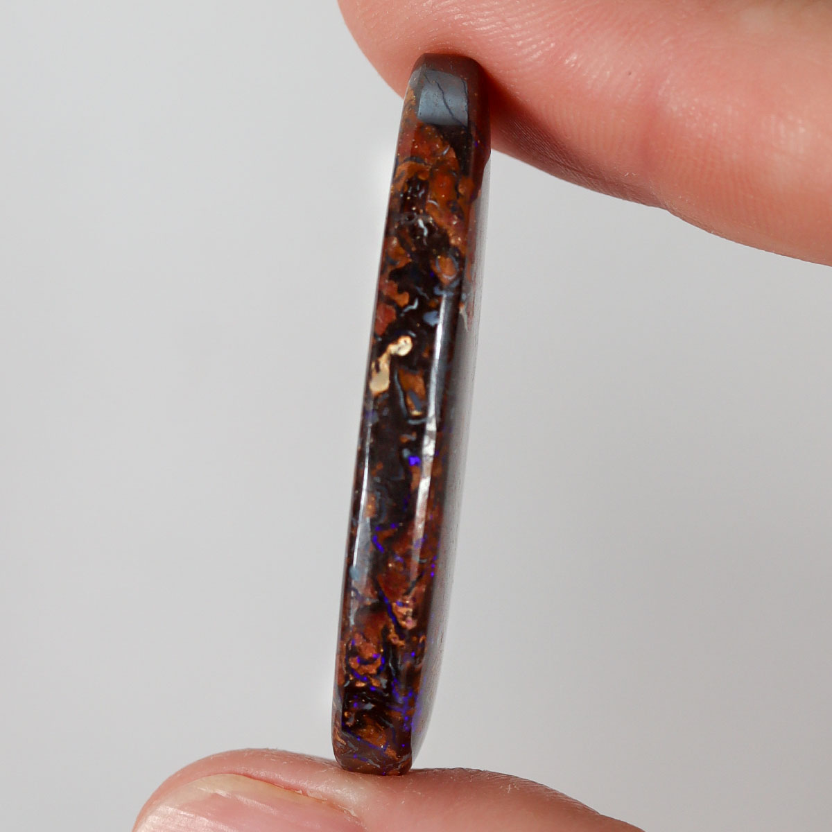 51.94ct boulder matrix held in hand for scale reference