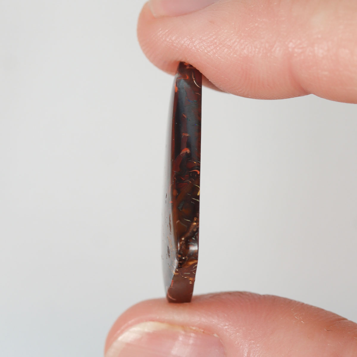 21.48ct boulder matrix held in hand for scale reference