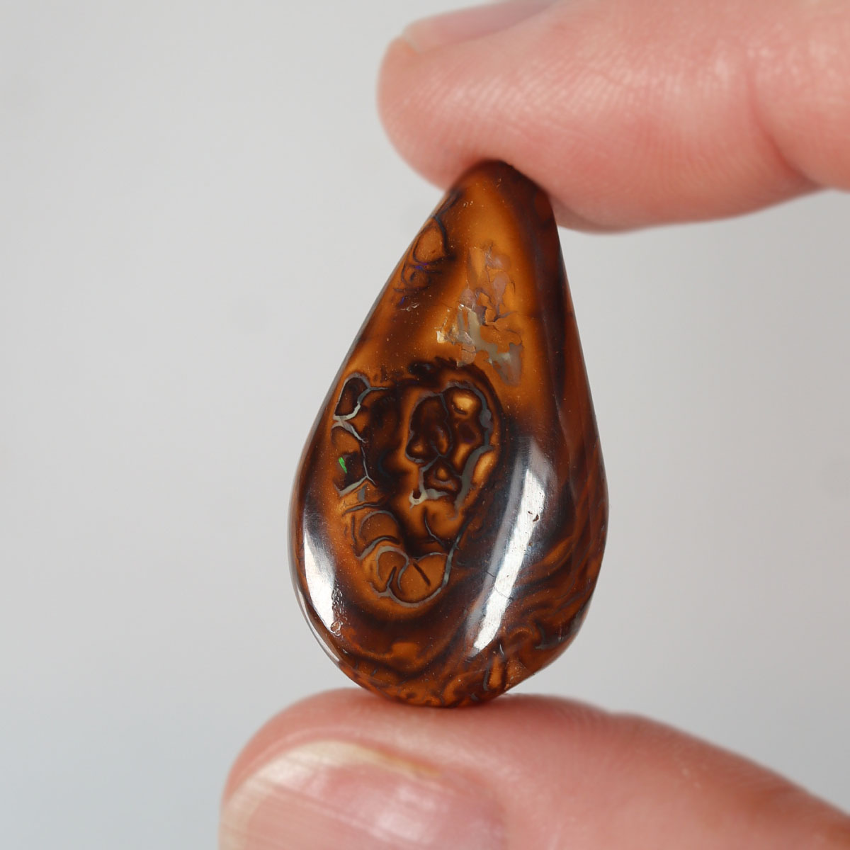 17.32ct boulder matrix cabochon from Koroit with boulder matrix play-of-colour