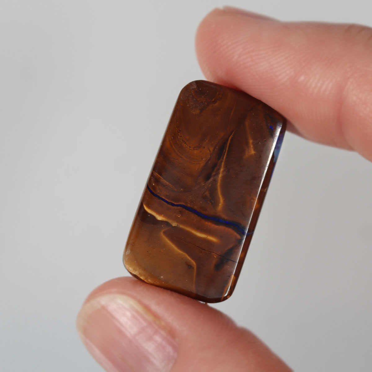 Side view of blue boulder matrix cabochon