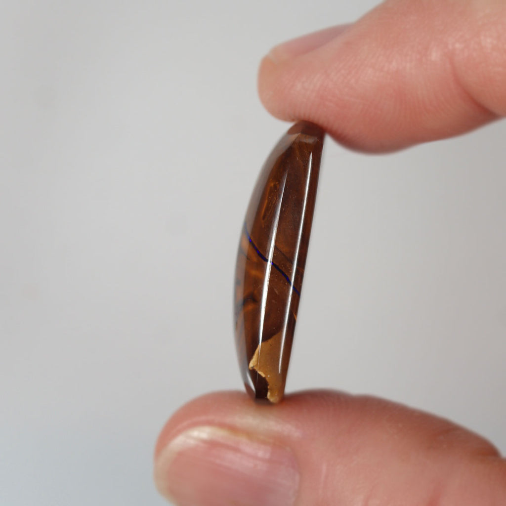 Boulder matrix from Koroit held in hand to show scale