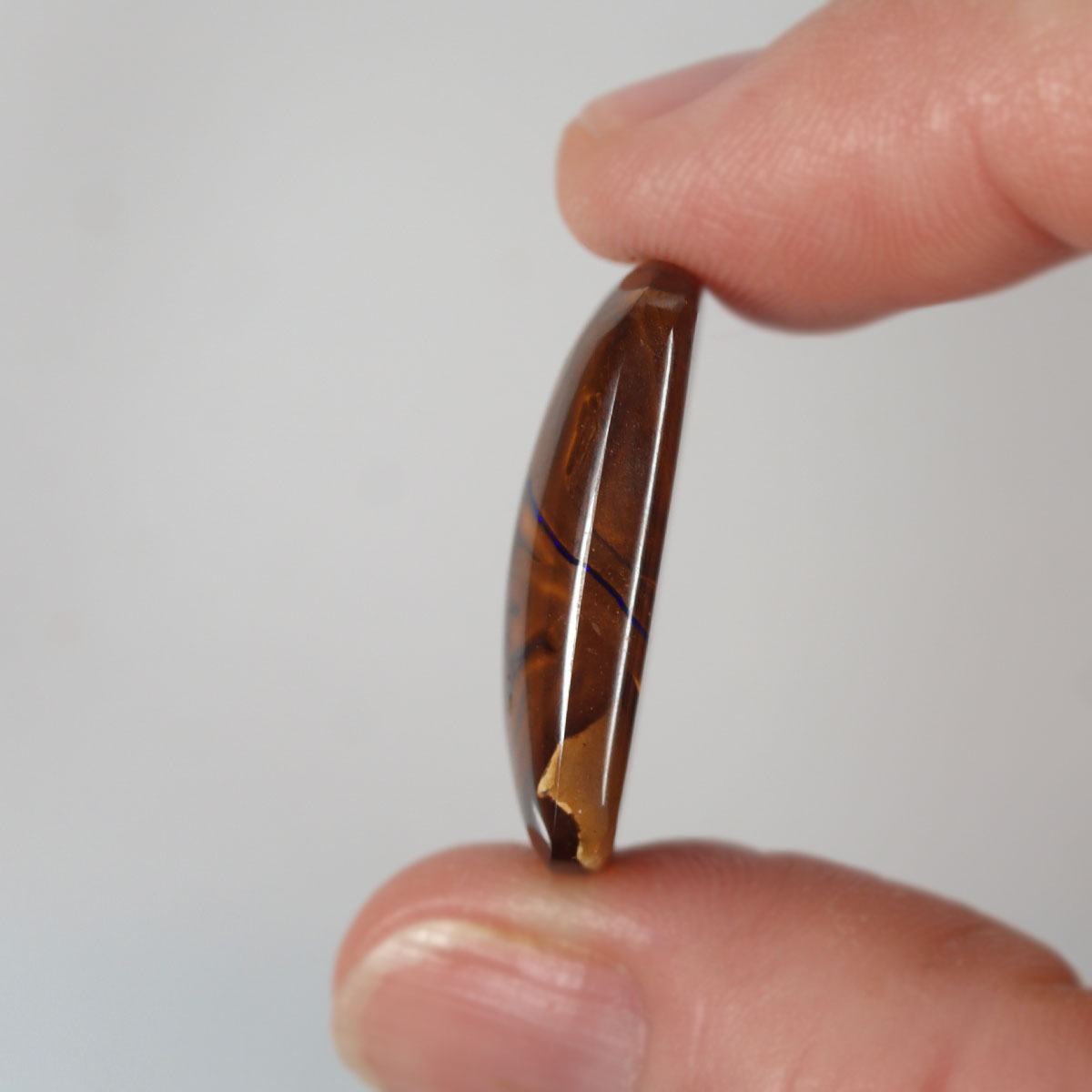 Boulder matrix from Koroit held in hand to show scale
