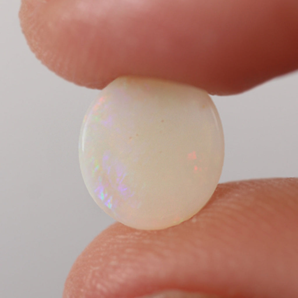 Macro detail of light opal cabochon