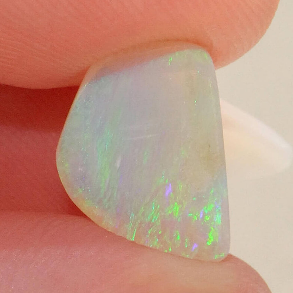 Detail of bright green flash on light opal