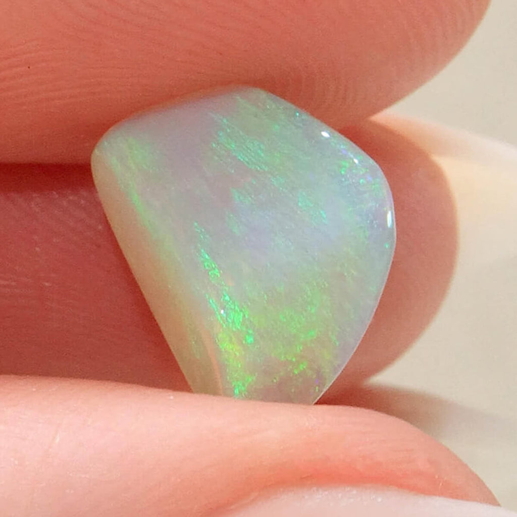 Light opal from Mintabie held in hand to show scale